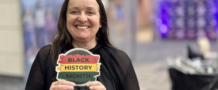 Person holding Black History Month cutout graphic